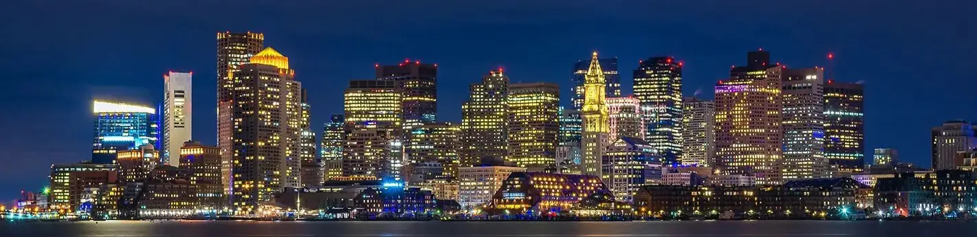 A city skyline with lights at night.